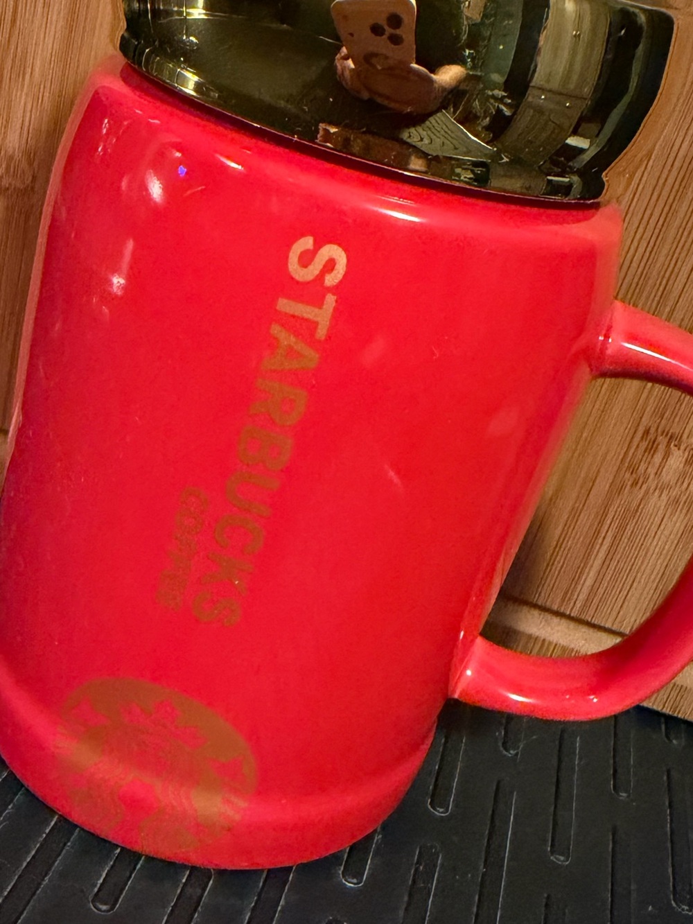 Starbucks ceramic mug with gold lid and mirror on top